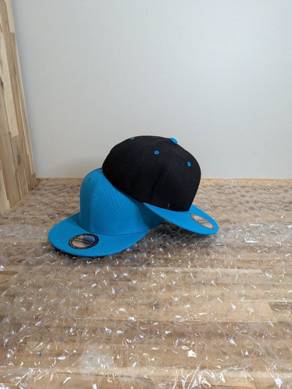 Light blue and black baseball caps.